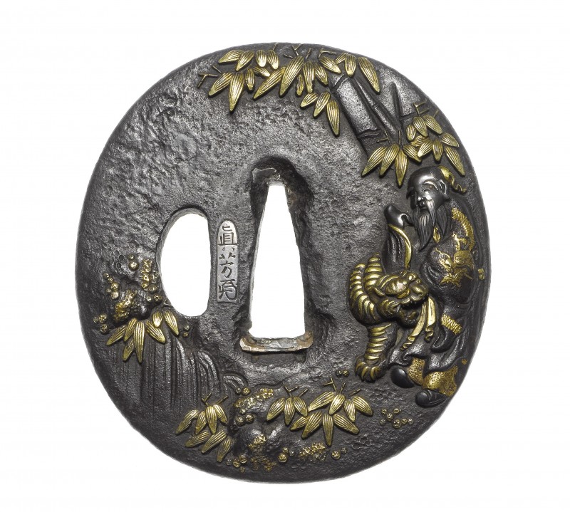 An iron tsuba
Arikawa School, early 19th century
Of oval form, carved in takabori and inlaid wit ...
