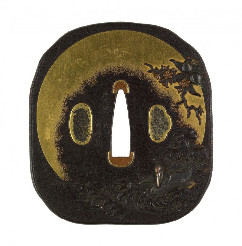 A crane is shown in waves at the lower right of the tsuba. Along the right and upper right is th ...