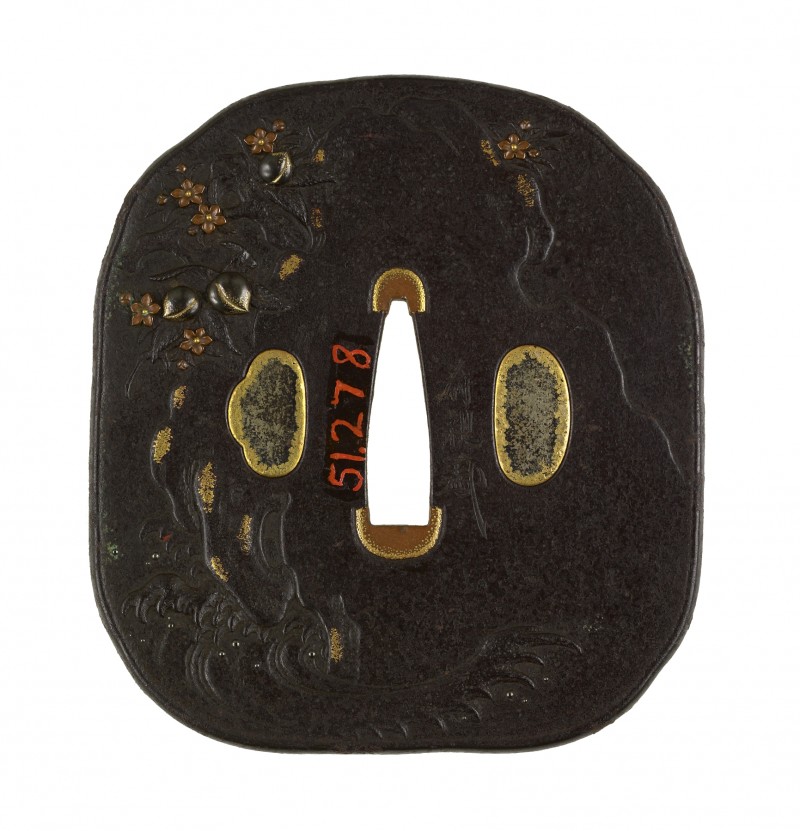 A crane is shown in waves at the lower right of the tsuba. Along the right and upper right is th ...
