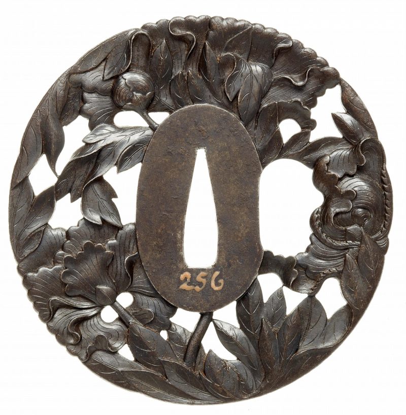 An iron tsuba. Edo period, second half 18th century

Of almost round shape, crisply carved and p ...