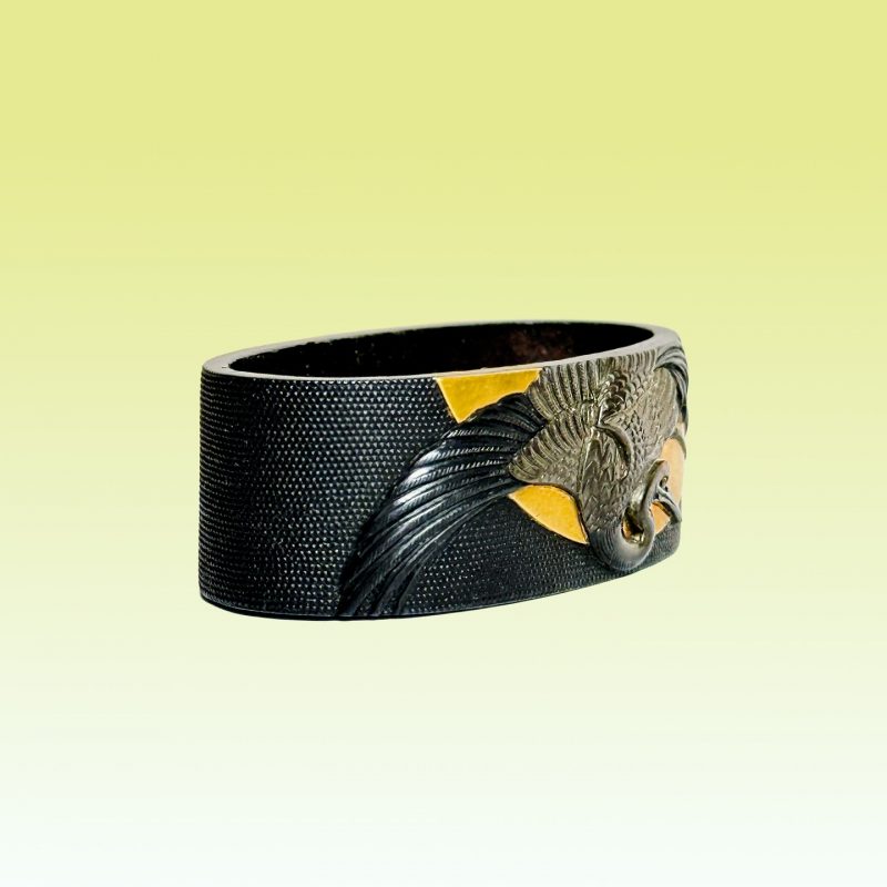 1744-1801 ( Edo period)

Tokubetsu Hozon

This is a magnificent fuchi made of shakudo, featuring ...