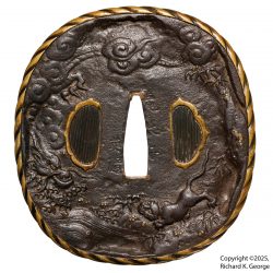 This tsuba is a bit of a beast.  It is made of iron with brass inlay and a brass mimi.  It measu ...