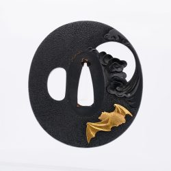 On a richly patinated shakudō ground, hammered with tsuchime to evoke the image of drifting clou ...
