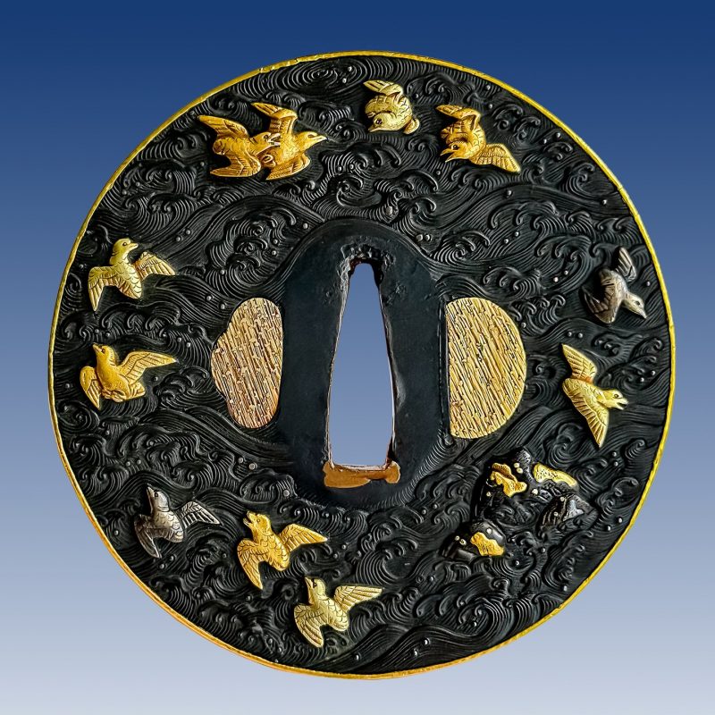 Tsuba with design of dancing cranes and plovers and waves.

With inscription “Soheishi, Mu ...