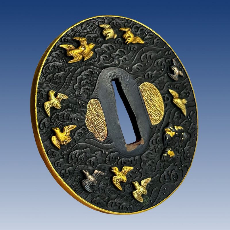 Tsuba with design of dancing cranes and plovers and waves.

With inscription “Soheishi, Mu ...